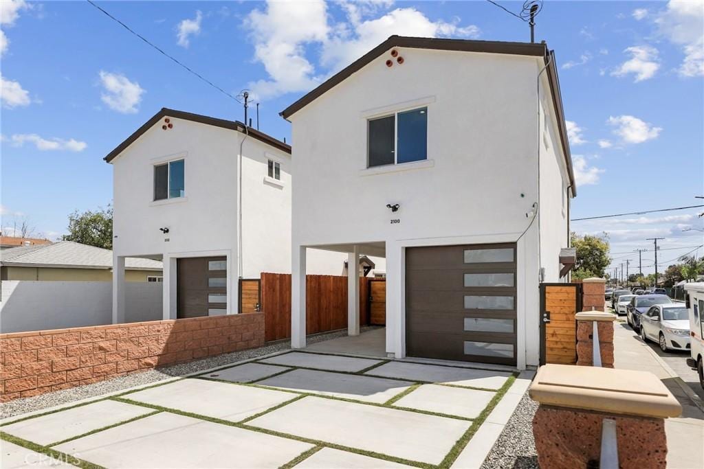2100 E Stockwell St, Compton, CA 90222 - view of front of property featuring a garage, stucco siding, and fence