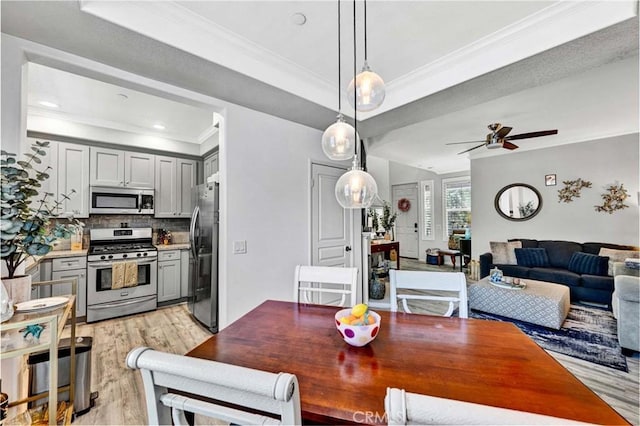 98 Hinterland Way, Ladera Ranch, CA 92694 - dining space featuring light wood-style flooring, crown molding, ceiling fan, and a tray ceiling