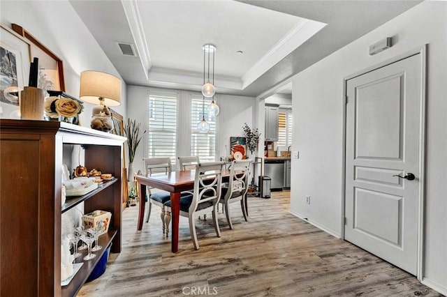 98 Hinterland Way, Ladera Ranch, CA 92694 - dining space with a tray ceiling, light wood-style flooring, ornamental molding, visible vents, and baseboards