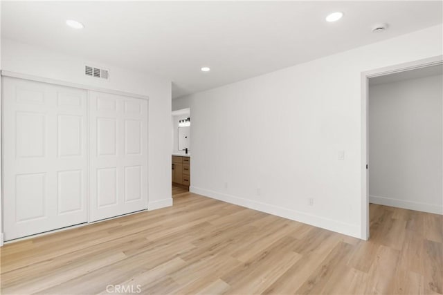 87 Tennessee St Unit C, Redlands, CA 92373 - unfurnished bedroom featuring light wood-type flooring, a closet, baseboards, and recessed lighting