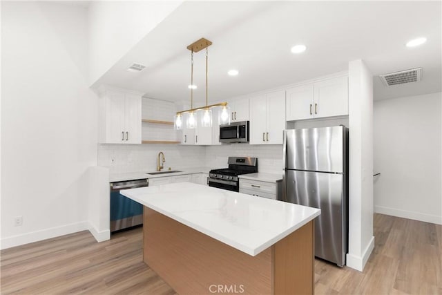 87 Tennessee St Unit C, Redlands, CA 92373 - kitchen featuring appliances with stainless steel finishes, open shelves, baseboards, decorative backsplash, and recessed lighting