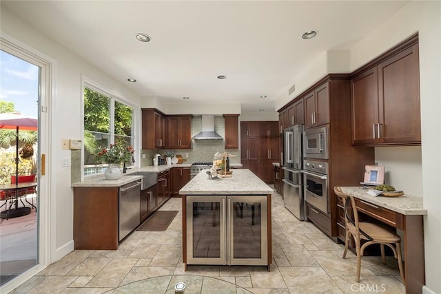 44 Edenbrook, Irvine, CA 92620 - kitchen with wall chimney range hood, light stone countertops, wine cooler, stainless steel appliances, and decorative backsplash