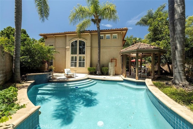 44 Edenbrook, Irvine, CA 92620 - back of property featuring stucco siding, a patio, fence, an outdoor pool, and a gazebo