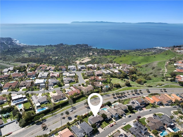 drone / aerial view with a water view and a residential view
