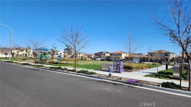 30874 Windy Ridge Way, Menifee, CA 92584 - view of asphalt road with a residential view, sidewalks, curbs, and street lighting