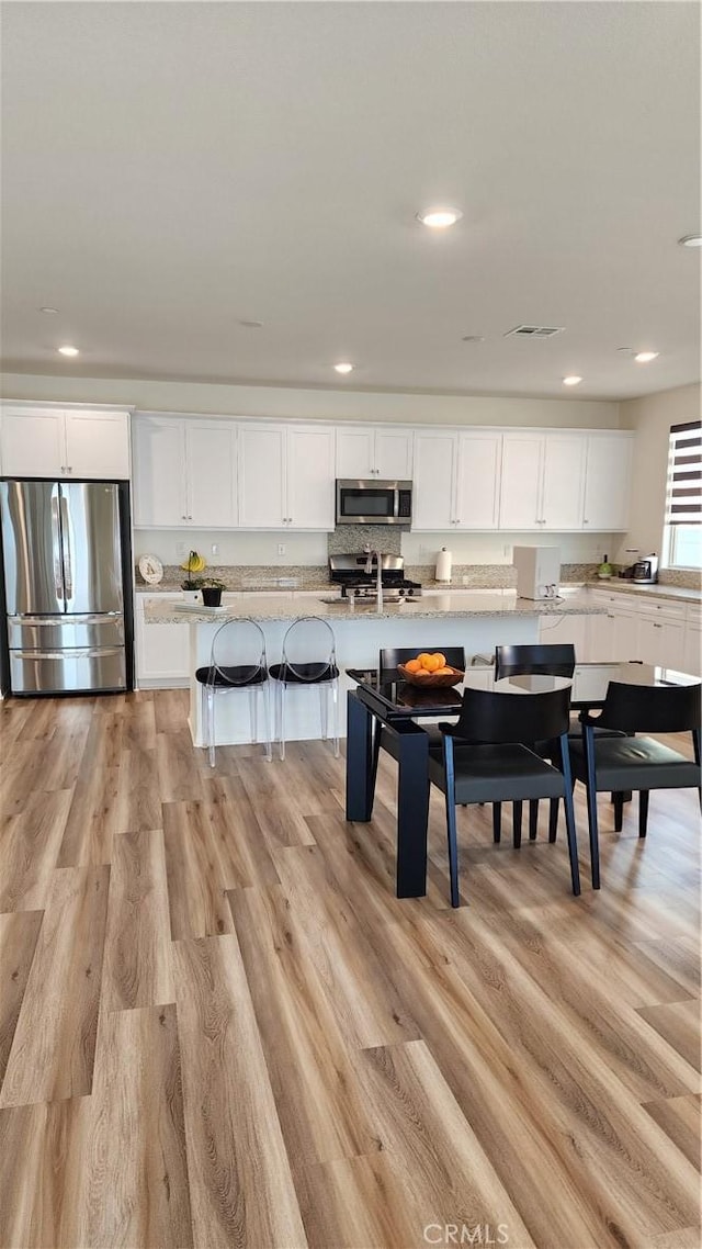 30874 Windy Ridge Way, Menifee, CA 92584 - dining room featuring light wood finished floors and recessed lighting