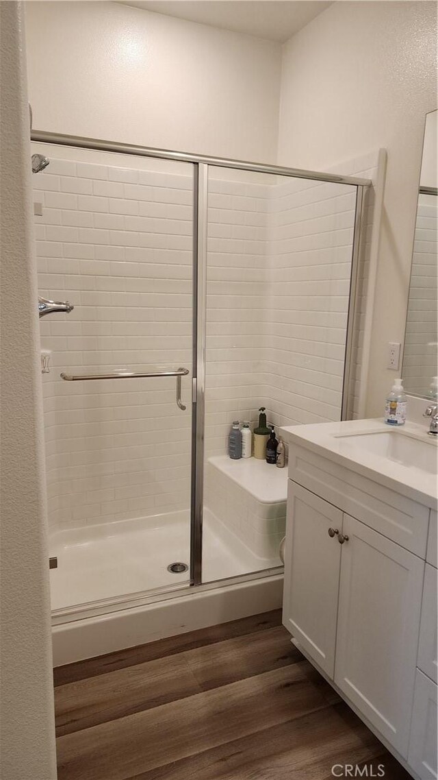 30874 Windy Ridge Way, Menifee, CA 92584 - full bathroom with vanity, a shower stall, and wood finished floors