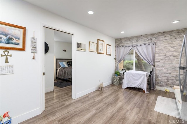bedroom featuring baseboards, recessed lighting, and wood finished floors