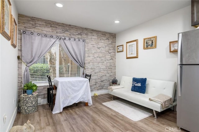 bedroom featuring light wood-style floors, freestanding refrigerator, baseboards, and recessed lighting