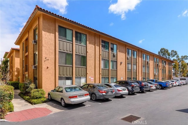 view of building exterior featuring uncovered parking