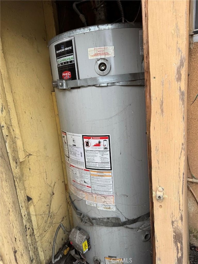 utility room featuring gas water heater
