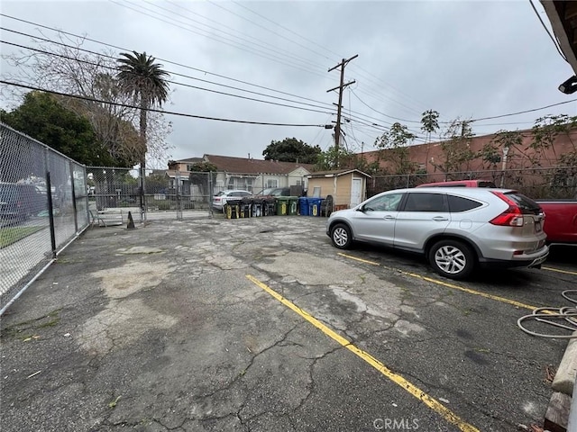 uncovered parking lot featuring fence