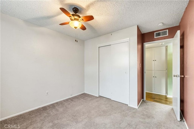1564 Monte Vista Ave, Rosamond, CA 93560 - unfurnished bedroom featuring light colored carpet, a textured ceiling, a closet, baseboards, and ceiling fan