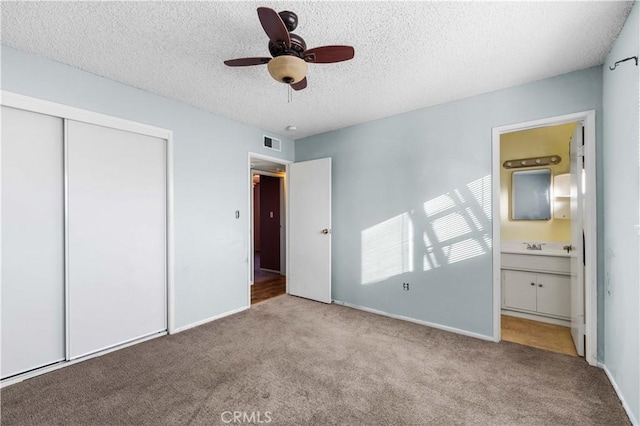 1564 Monte Vista Ave, Rosamond, CA 93560 - unfurnished bedroom featuring carpet, a closet, a textured ceiling, connected bathroom, and baseboards