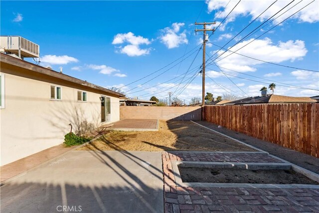 1564 Monte Vista Ave, Rosamond, CA 93560 - fenced backyard featuring a patio area and a vegetable garden