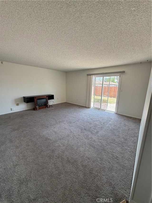 1564 Monte Vista Ave, Rosamond, CA 93560 - unfurnished living room with a textured ceiling and carpet