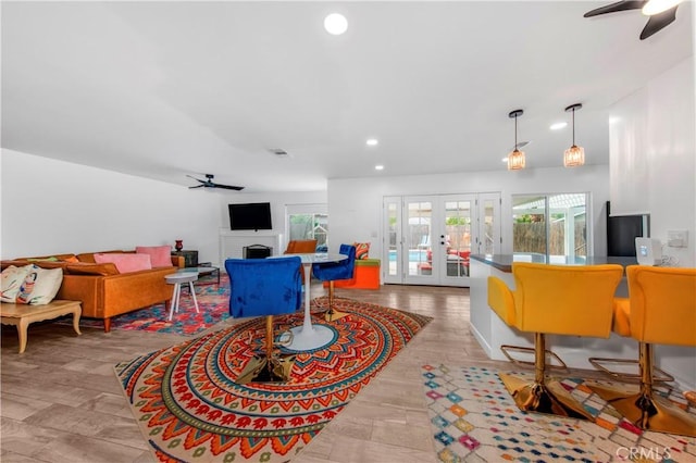 living room featuring ceiling fan, a fireplace, french doors, recessed lighting, and visible vents
