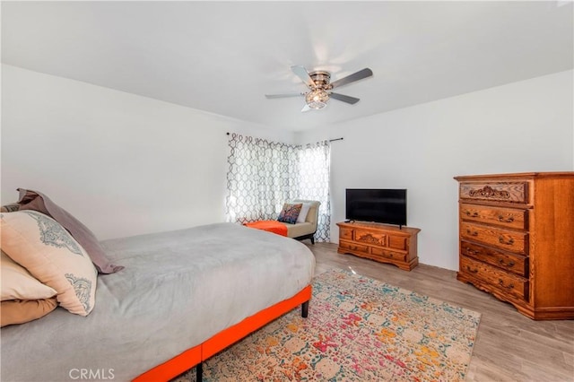 bedroom with a ceiling fan and light wood finished floors