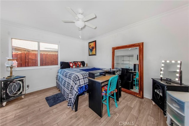 bedroom featuring crown molding, baseboards, ceiling fan, and light wood finished floors