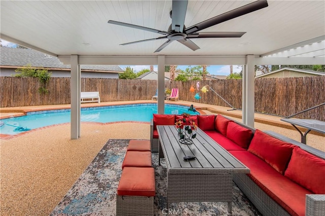 view of pool with a patio, a fenced backyard, ceiling fan, and an outdoor hangout area