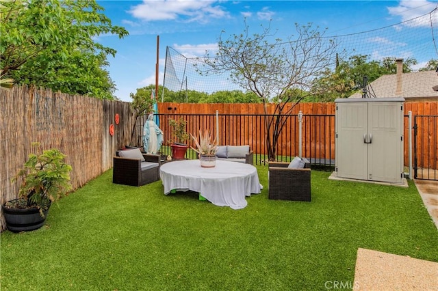 view of yard featuring a fenced backyard, an outbuilding, and a storage shed