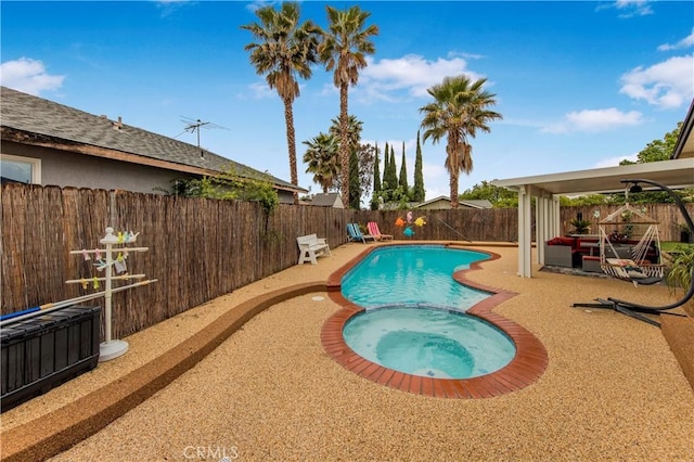 view of pool featuring a patio, a fenced backyard, and a pool with connected hot tub