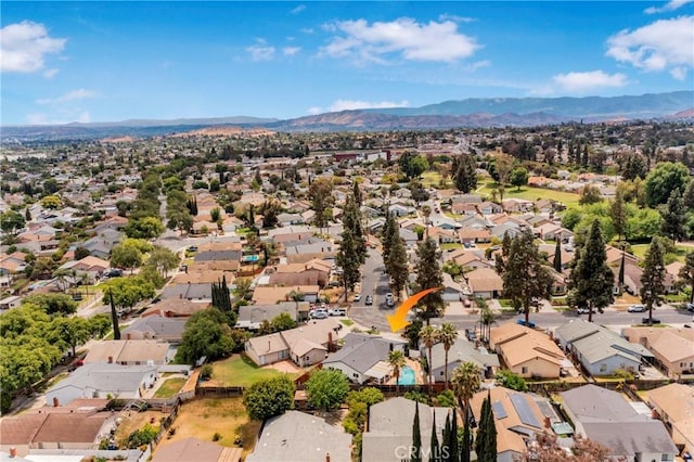 drone / aerial view featuring a residential view and a mountain view