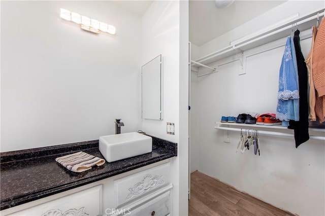 bathroom with vanity and wood finished floors