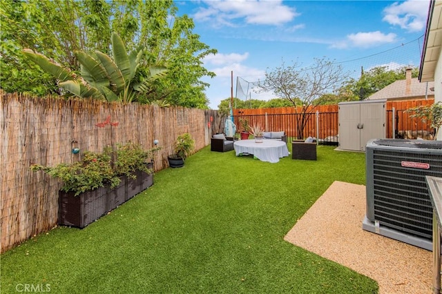 view of yard with an outdoor structure, cooling unit, a shed, and a fenced backyard
