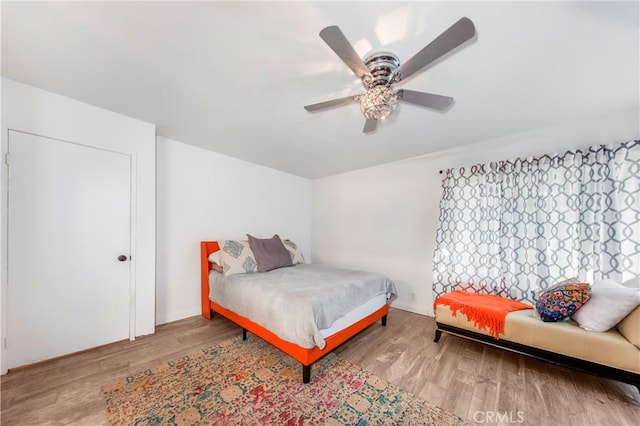 bedroom with a ceiling fan and wood finished floors