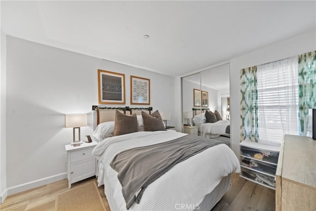 1040 Calle Del Cerro Unit 101, San Clemente, CA 92672 - bedroom featuring light wood finished floors, a closet, and baseboards