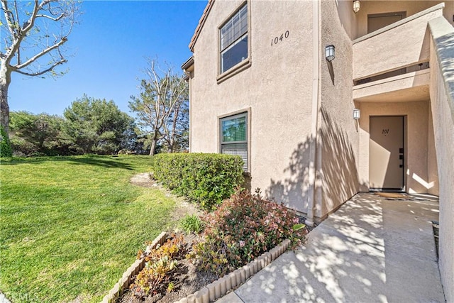 1040 Calle Del Cerro Unit 101, San Clemente, CA 92672 - view of side of home with stucco siding and a lawn