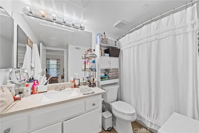 1040 Calle Del Cerro Unit 101, San Clemente, CA 92672 - bathroom with toilet, vanity, and wood finished floors