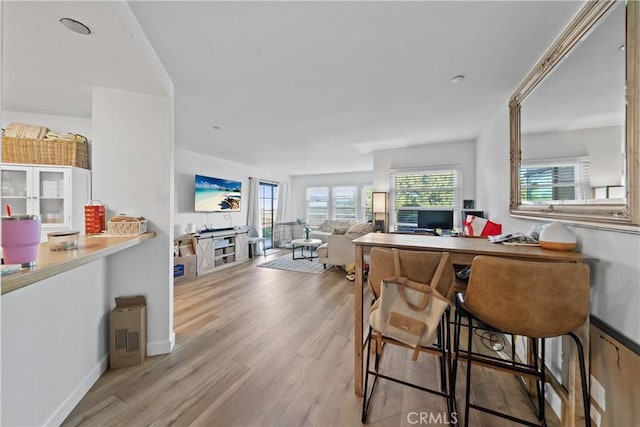 1040 Calle Del Cerro Unit 101, San Clemente, CA 92672 - kitchen with light wood-type flooring, baseboards, and an office area