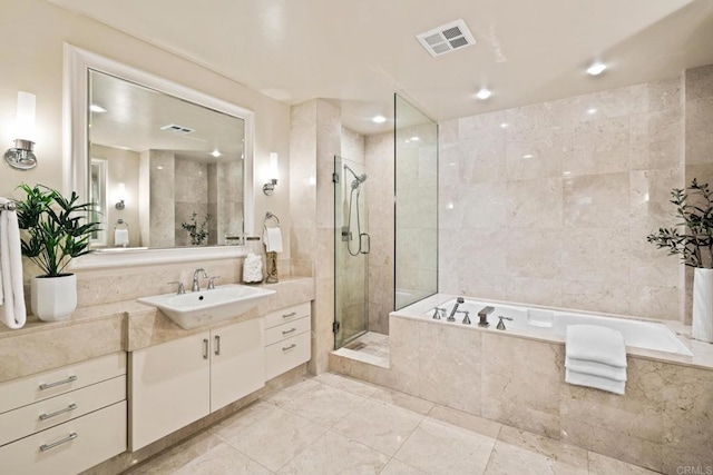 bathroom with a garden tub, visible vents, a shower stall, and vanity