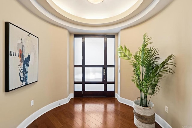 foyer with wood finished floors and baseboards