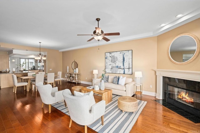 living room featuring a high end fireplace, recessed lighting, a ceiling fan, and wood finished floors