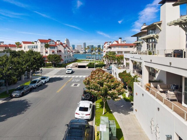 view of street featuring sidewalks, curbs, and a city view