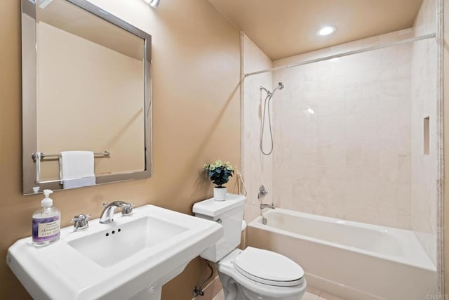 bathroom featuring toilet, recessed lighting, a sink, and shower / bathing tub combination