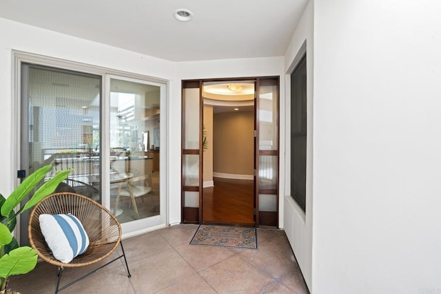 interior space featuring tile patterned floors and baseboards