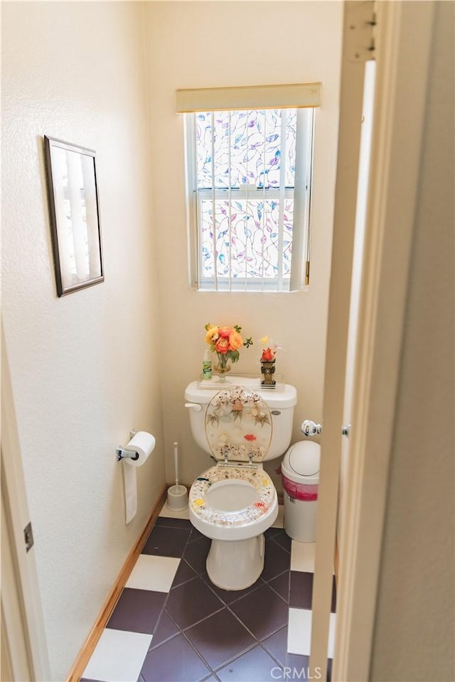 bathroom featuring toilet and tile patterned flooring