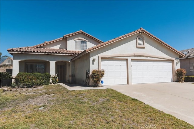 mediterranean / spanish-style home featuring stucco siding, a front yard, a tile roof, an attached garage, and concrete driveway