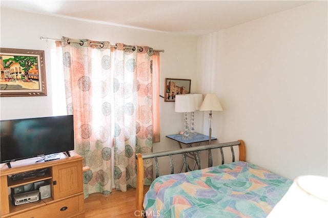 bedroom with wood finished floors