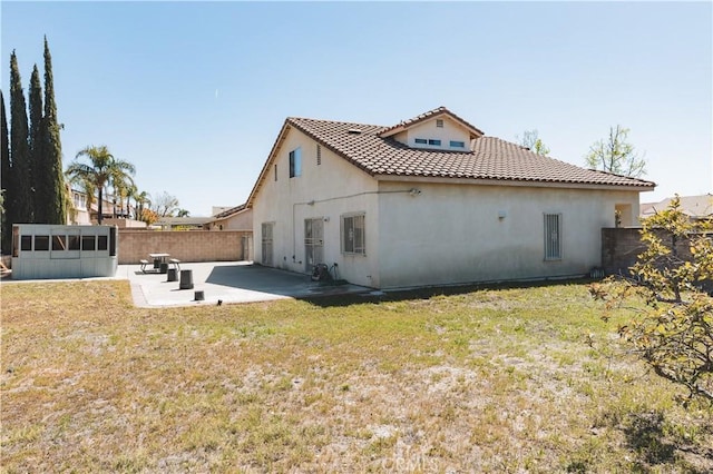rear view of property featuring a yard, a patio area, a fenced backyard, and stucco siding
