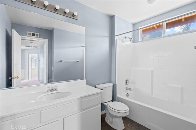 bathroom with visible vents, toilet, vanity, shower / bath combination, and tile patterned floors
