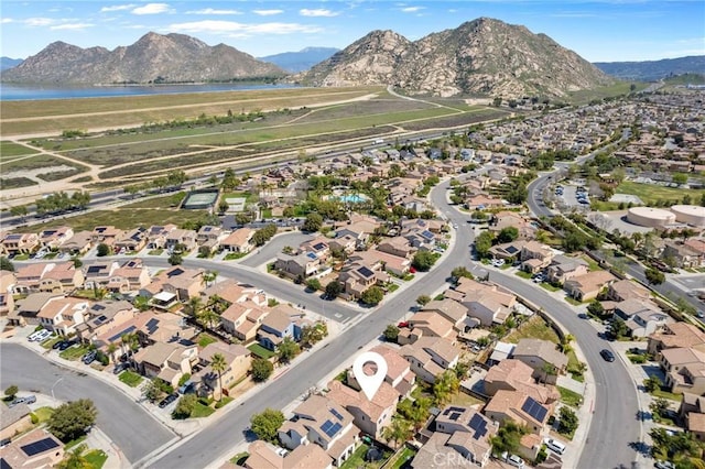 drone / aerial view featuring a water and mountain view and a residential view