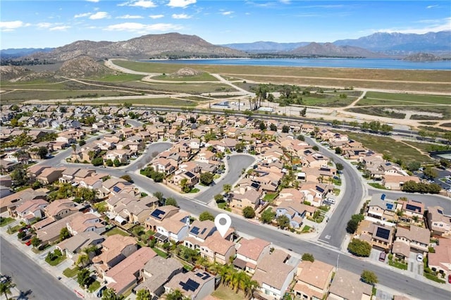 drone / aerial view with a residential view and a water and mountain view