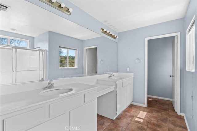 full bathroom with vanity, baseboards, and visible vents