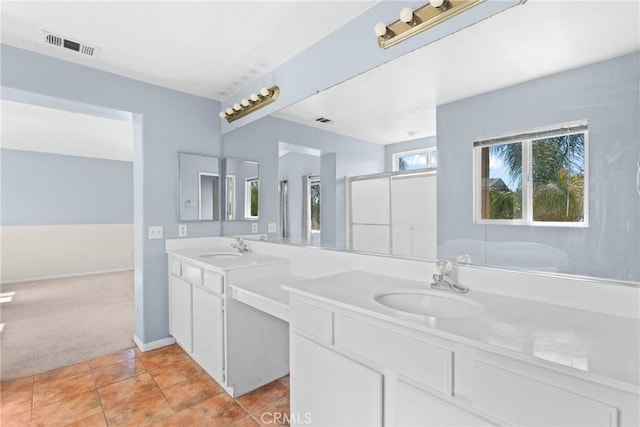 full bathroom with a sink, visible vents, double vanity, and tile patterned flooring