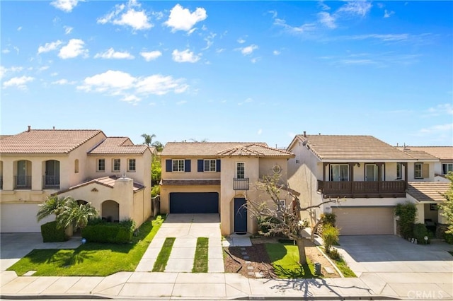 view of front of house with a tiled roof, concrete driveway, stucco siding, and a garage